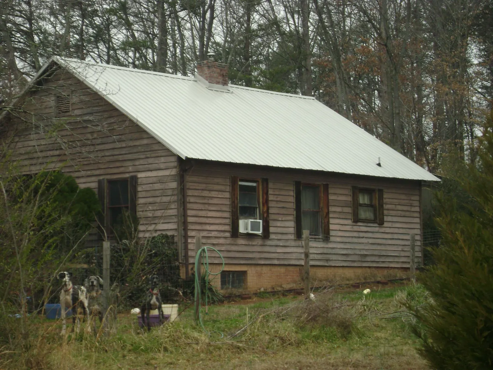White metal roof on an old wood sided farmhouse, from a Asphalt Shingle Roof Repair job in Council Bluffs
